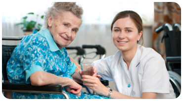caregiver giving patient a glass of water